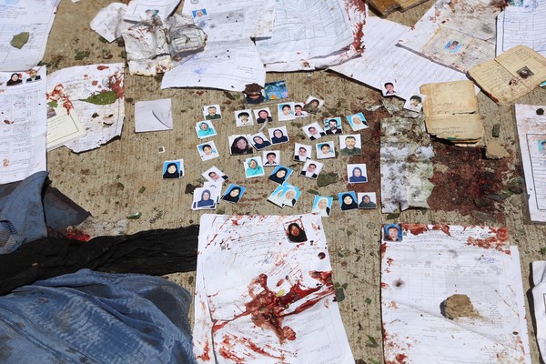 ▲▼阿富汗選民中心遭到伊斯蘭國（IS）恐怖攻擊，地上隨處可見染血的身分證件和選民大頭照片。（圖／達志影像／美聯社）