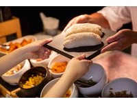 手握飯糰包著肉鬆、菜脯及餐廳自製的油條。