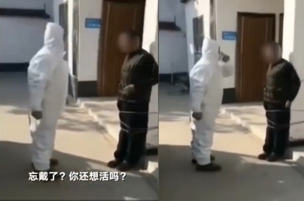 執法過當！？沒戴口罩男趴趴走　被防疫人員綁在柱上：嚇嚇他而已。（圖／翻攝自新京報我們視頻）