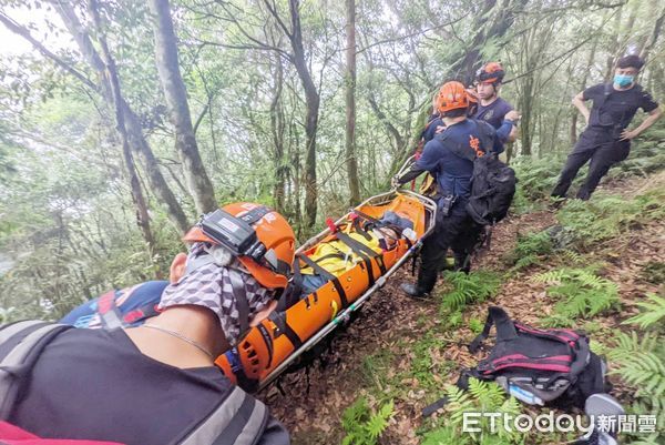 ▲桃園市消防局1日下午登山尋獲滑落溪谷負傷劉姓女子，在陡峭山坡上接力護送下山。（圖／記者沈繼昌翻攝）