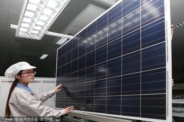 2014年5月21日，江蘇連雲港市贛榆縣經濟開發區神舟新能源公司的工人在檢驗出口歐美的太陽能光伏產品。（圖／CFP）
