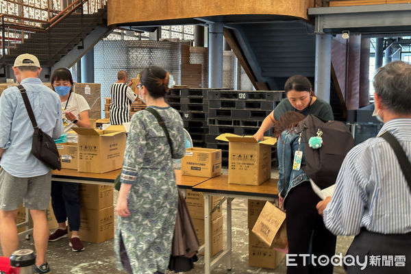 ▲中鋼股東會紀念品指定兌換處,很多小股東拿著開會通知書前往兌換。(圖/記者楊絡懸攝)