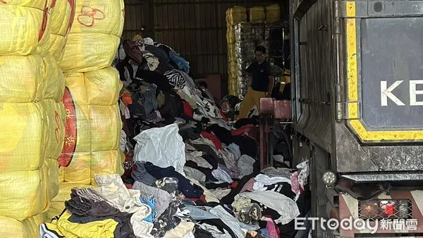 ▲高雄市一名女子被舊衣壓在底下,消防人員進行搶救 。(圖/記者吳世龍攝)