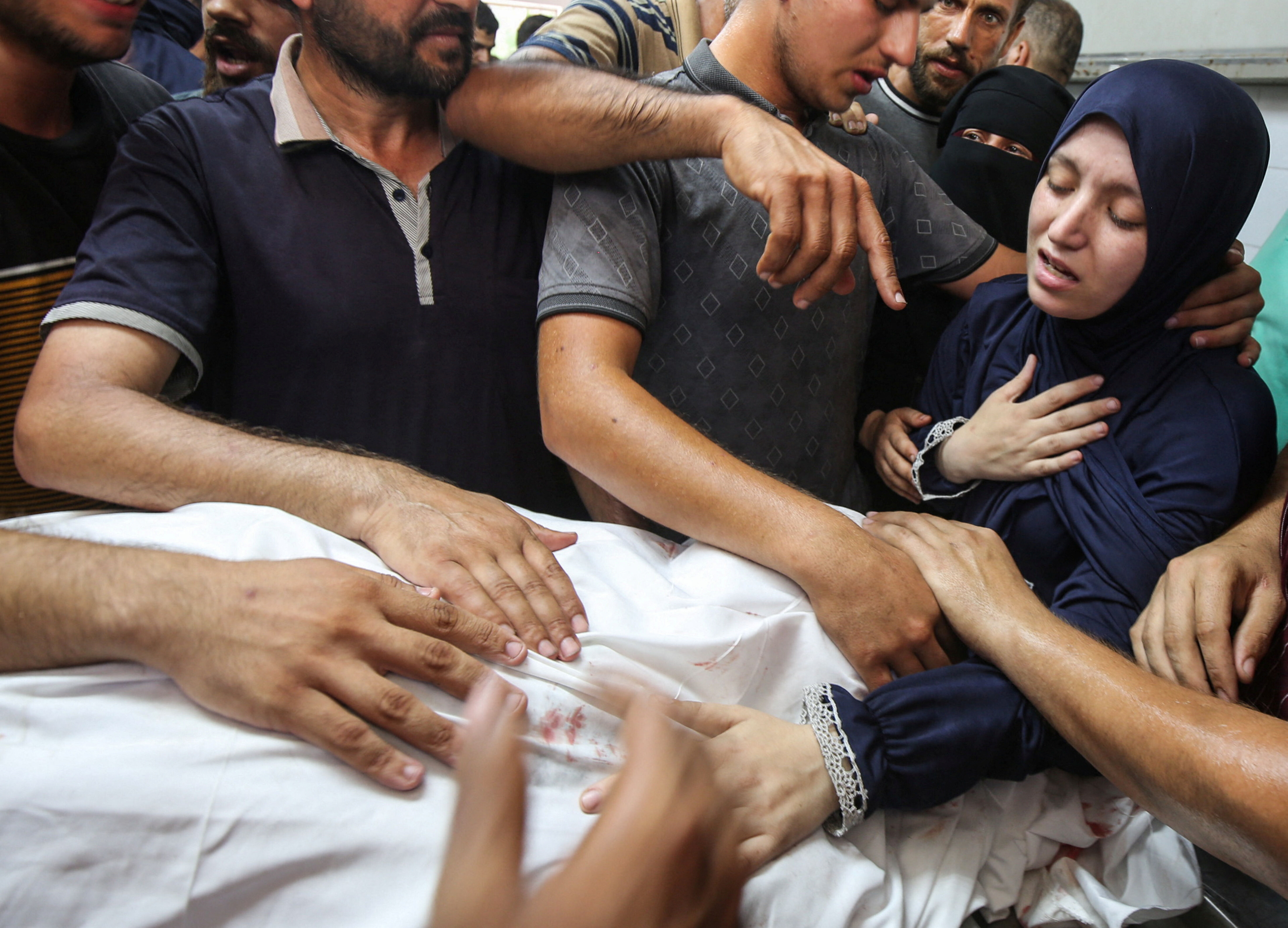 ▲▼加薩資深心臟科醫師馬爾旺・蘇丹(Marwan al-Sultan)遭以軍空襲身亡,家人悲痛擁著遺體哭泣。(圖/路透)