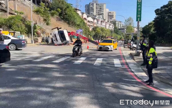 ▲汐止康寧街吊車翻覆加上有公車拋錨,警方緊急到場疏導交通。(圖/記者張君豪翻攝)