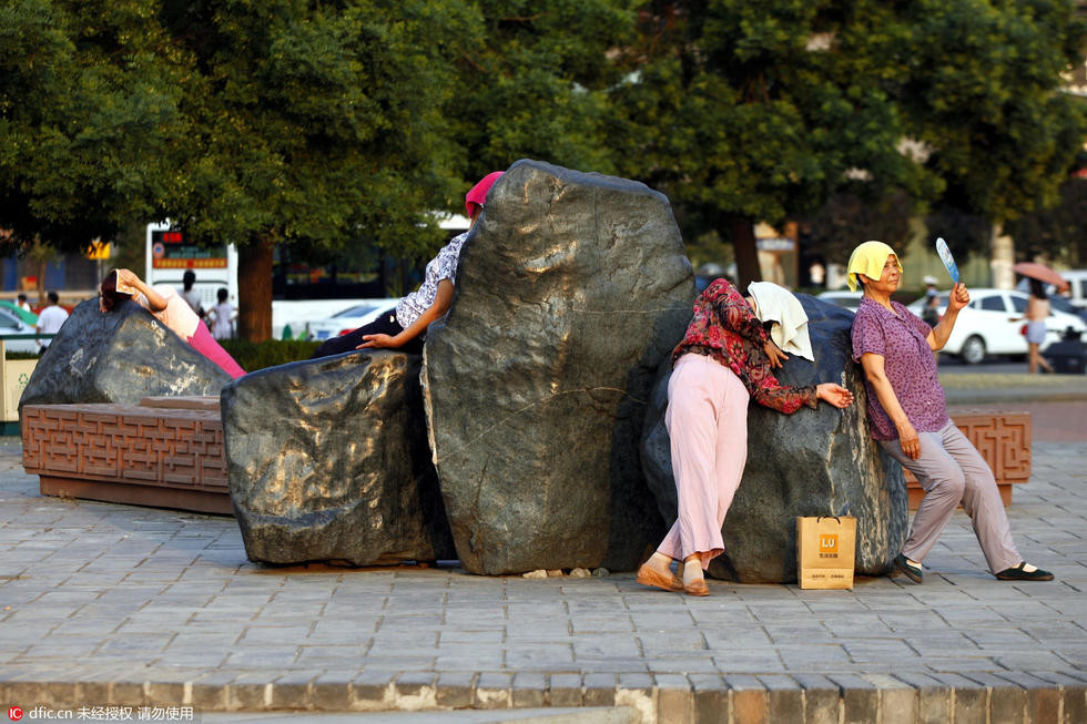 ▲中國大媽躺在西安環城公園3塊大石頭上。（圖／翻攝自微博）