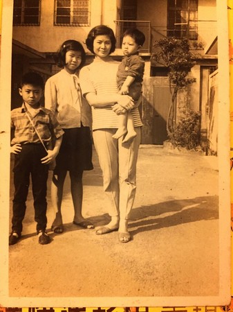 邵昕的母親易秀楓（右2）抱著年幼的邵昕，站在尚未改建前的立祥公寓。左起為邵昕大哥邵陽、傭人阿滿。（邵昕提供）