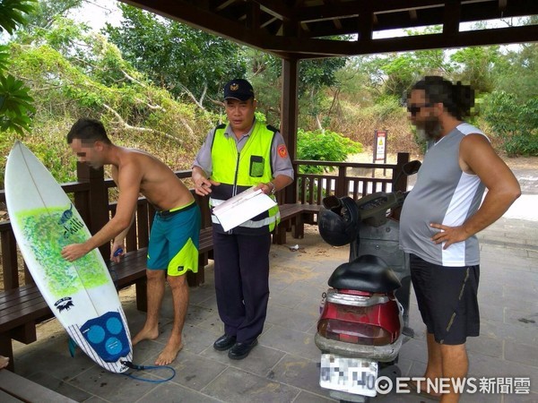 ▲有外國遊客趁颱風前往海邊衝浪，遭警方開勸導單並強制撤離。（圖／記者林煒傑翻攝）