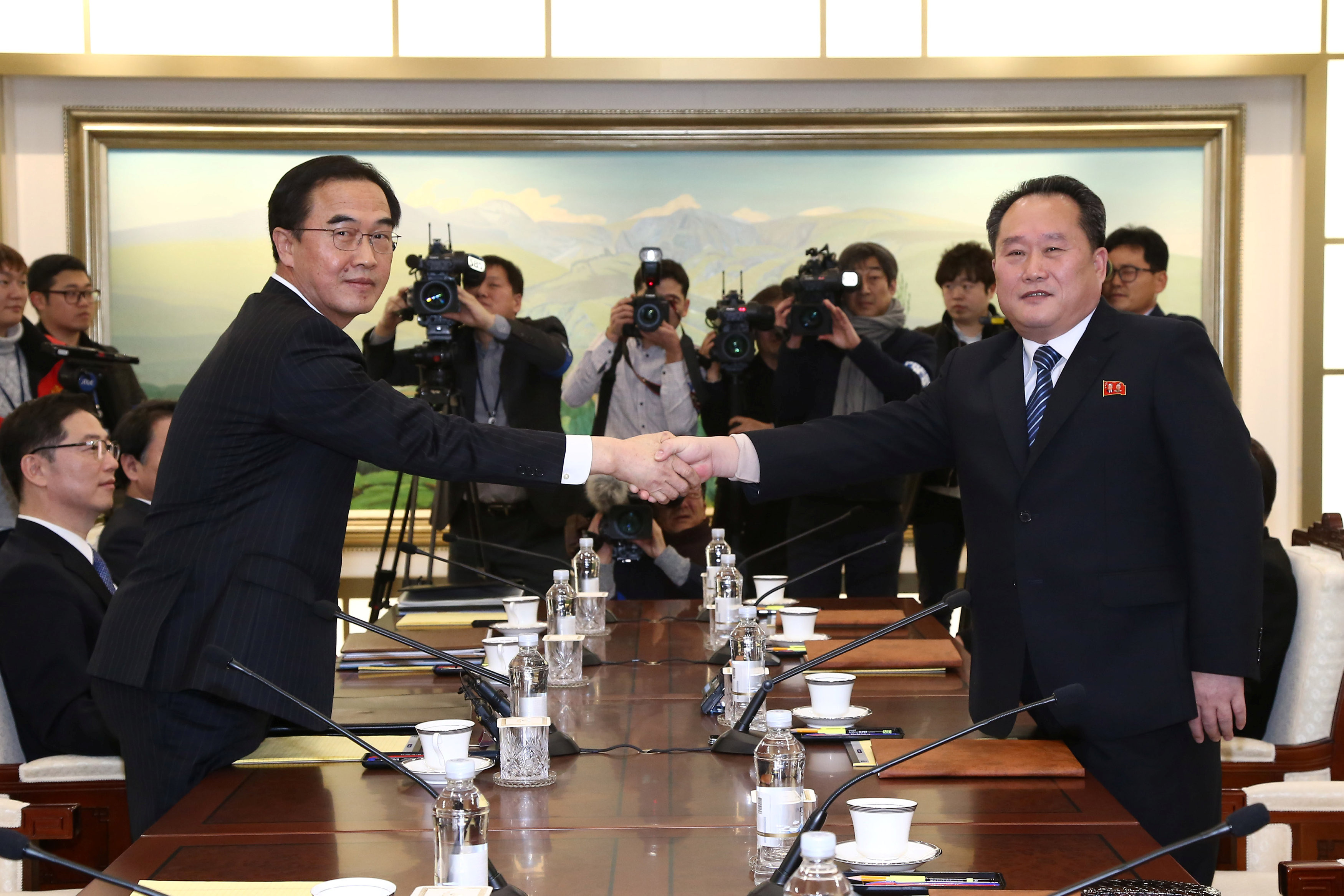 ▲南韓統一部長趙明均（左）與北韓祖國和平統一委員會委員長李善權在板門店「和平之家」握手言歡。（圖／路透社）