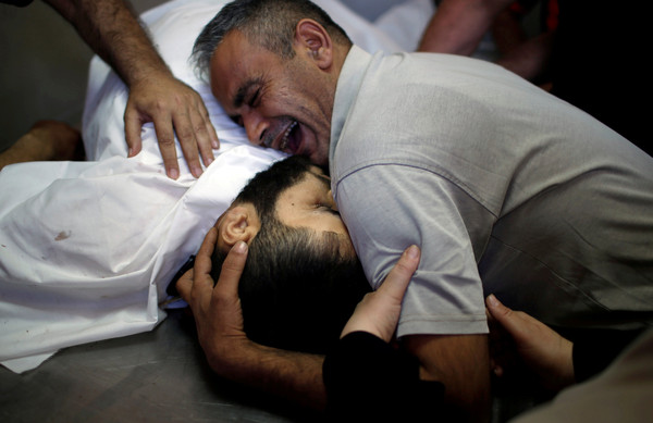 ▲ 有大量巴勒斯坦人在加薩走廊和以色列邊界示威造成死傷，家屬抱著死者遺體哀痛大哭。（圖／路透社）