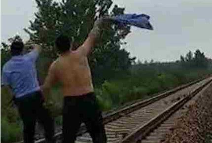 ▲大樹倒在鐵軌上　警員「脫衣揮舞」攔火車…差4秒撞上！。（圖／翻攝微博）