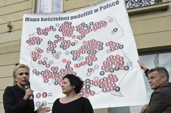▲▼示威者舉起波蘭地圖以黑色十字架標示性侵事件地名。（圖／美聯社）