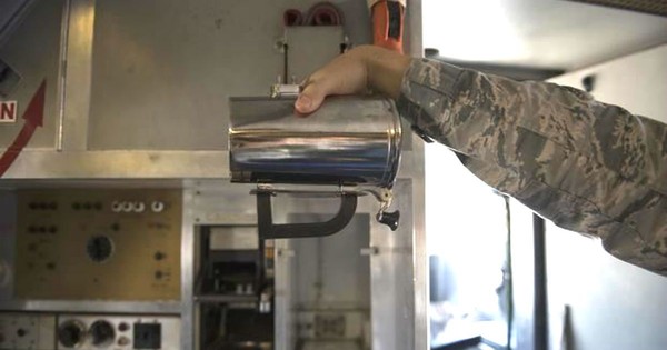 ▲一名空軍正在展示這款天價的金屬馬克杯     。(圖／美國空軍照片)