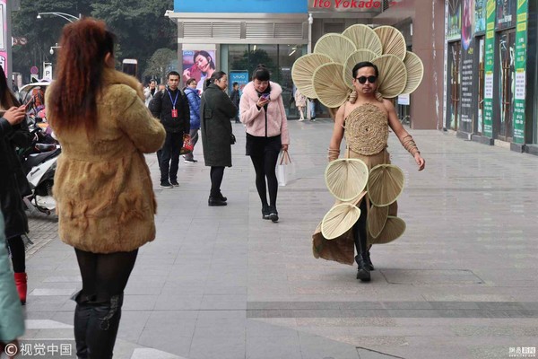 ▲▼今年38歲的豆小剛穿上自己純手工製作的環保時裝走在街頭。（圖／視覺中國）