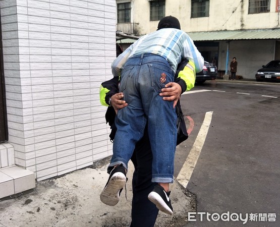 ▲桃園市警局平鎮分局員警上午尋獲失蹤協尋的宋姓男子，員警張政華揹起無法行走的宋男回派出所安置。（圖／記者沈繼昌翻攝）