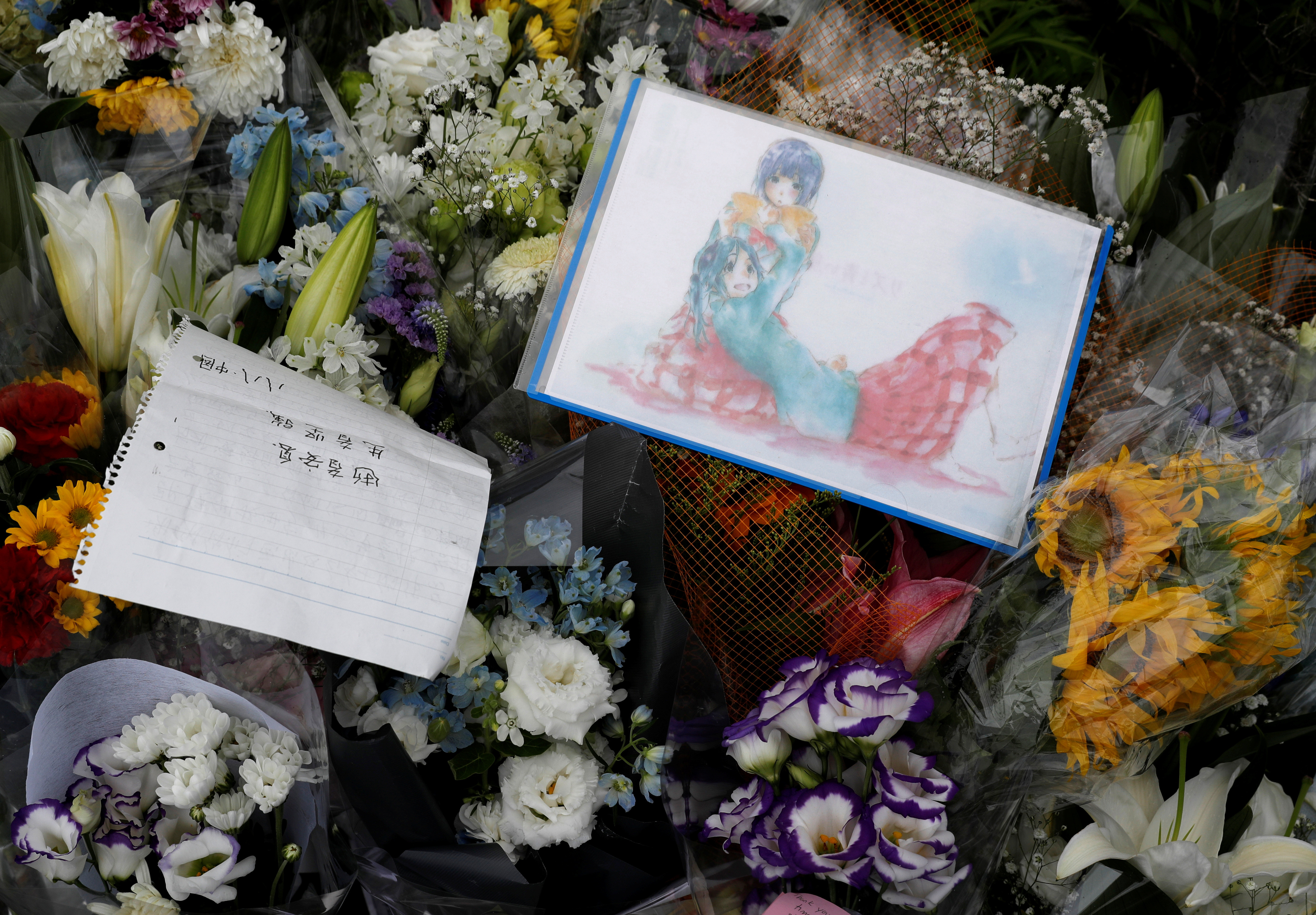 ▲▼京都動畫縱火案，支持者在現場留下花束和手繪動畫角色獻給受難者。（圖／路透）