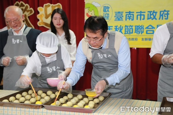 ▲台南市長黃偉哲到朝興啟能中心，嘗試DIY做烏豆沙蛋黃月餅，共同為憨兒親手製作的月餅進行宣傳。（圖／記者林悅翻攝，下同）