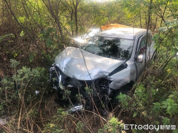 ▲計程車遭銀色自小客車攔腰撞上，雙雙飛入草叢，車身受損嚴重可見當時力道猛烈。（圖／記者蔡佩旻翻攝）