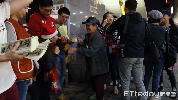 ▲Wecare大遊行前一天，發起人之一尹立來到中央公園站出口發「光復高雄」貼紙             。（圖／記者吳奕靖攝）