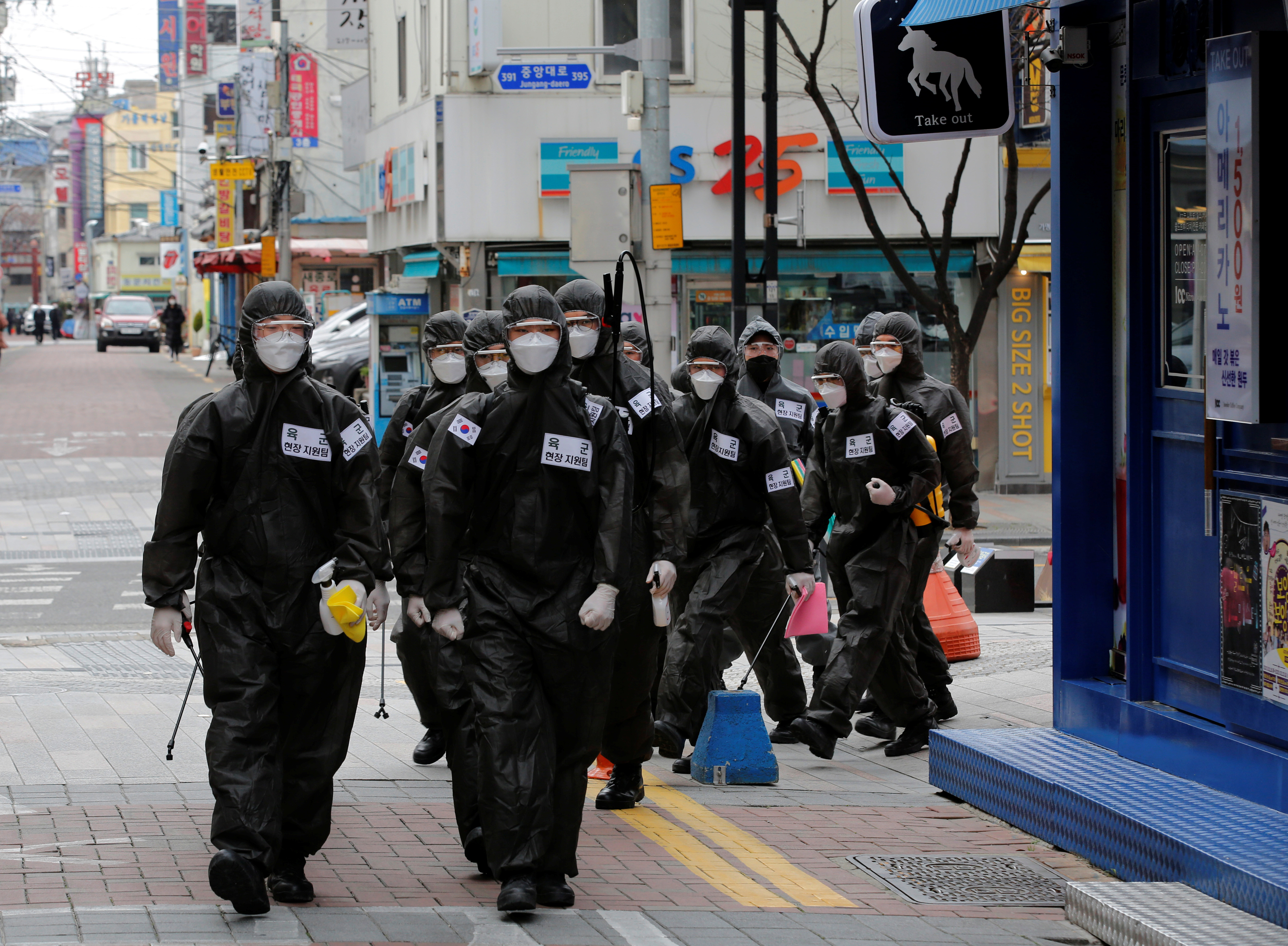 ▲▼身穿防護服的南韓士兵為大邱市中心建築物進行消毒。（圖／路透）