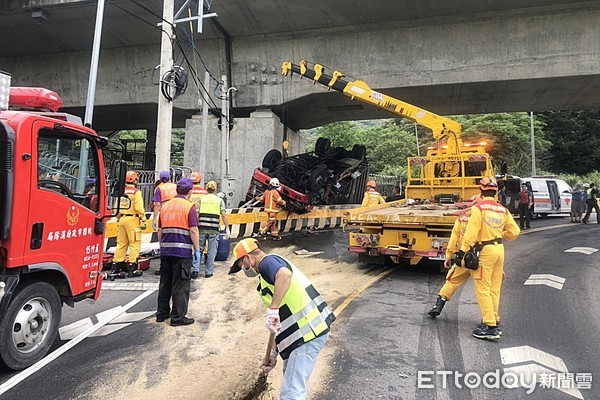 ▲桃園市一輛大貨車11日上午在蘆竹區仁愛路三段彎道翻覆，現場灑落大量油漬，工人以木屑清理中。（圖／記者沈繼昌翻攝）