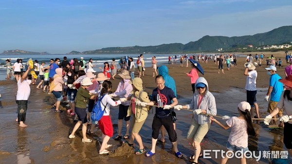 ▲大手牽小手！百人與大海拔河 北海岸重溫百年「牽罟」捕魚。（圖／新北市金山區公所提供）