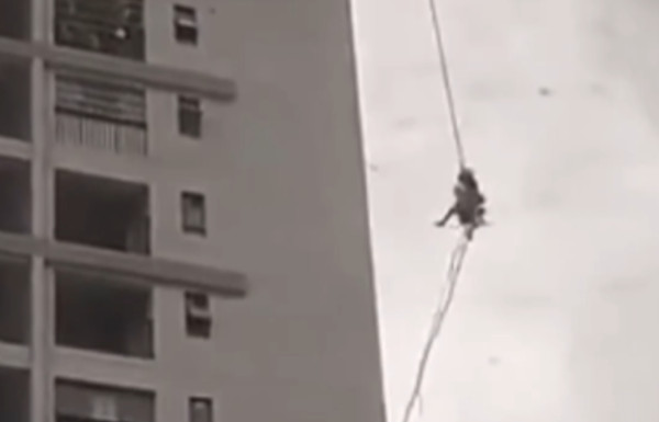 高空作業遇恐怖強風！　2工人死命抓繩子「空中不斷打轉」撞牆。（圖／翻攝自YouTube／漩渦視頻）