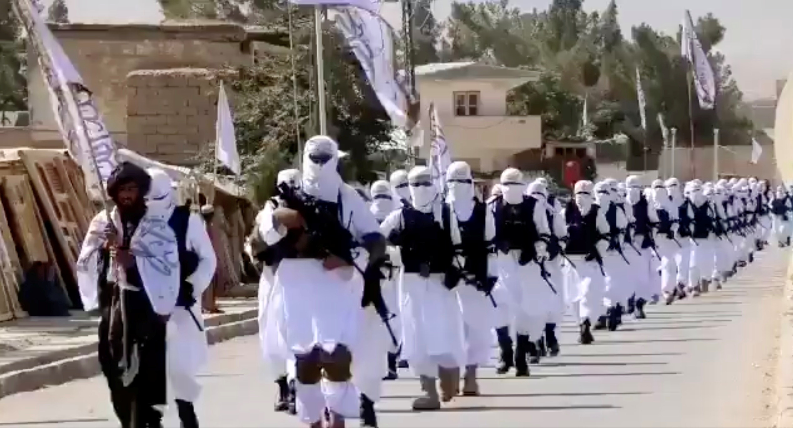 ▲▼  塔利班發布一段影片，組織成員身穿白袍、防彈背心，持槍走在南部扎布爾省首府卡拉特（Qalat）街道。（圖／路透）