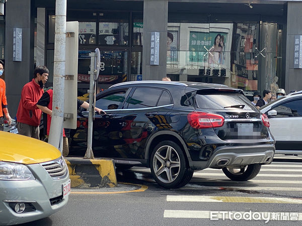 ▲1部賓士車連撞圓環分隔島，失撞再撞中山路分隔島車才停下，造成車頭及底盤部分嚴重毀損漏油，車頭及車體碎片散落一地。（圖／記者林悅攝，下同）