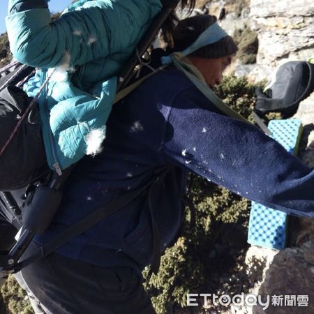 ▲玉山排雲山莊人員將南峰罹難山友揹負至空曠處，等待空勤直升機吊掛。（圖／記者高堂堯翻攝）