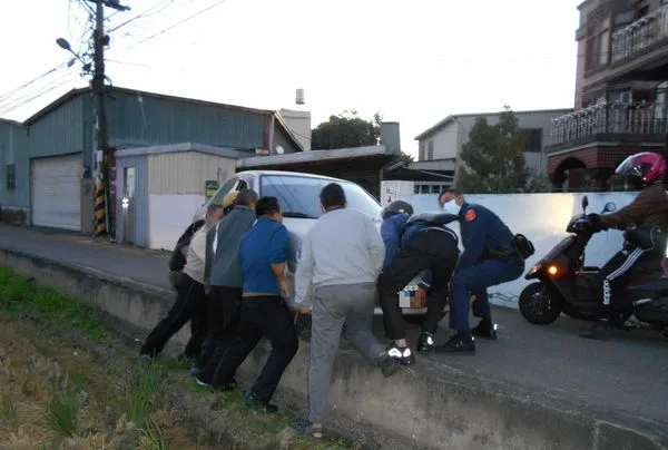 ▲▼女業務員路況不熟，結果愛車車輪懸空，員警、居民和路人共8人合力抬離脫困。（圖／警方提供）