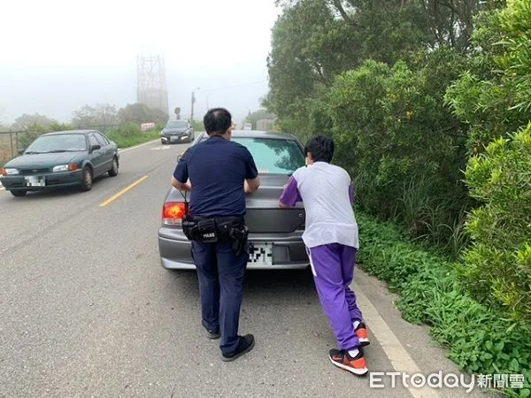 ▲員警將刁路中故障車推向路旁。（圖／龍潭警分局提供）