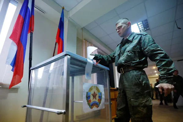 ▲▼烏克蘭被佔領區，自稱盧甘斯克人民共和國（LPR）一處軍事單位的軍人領取選票，參加「入俄公投」投票。（圖／路透）
