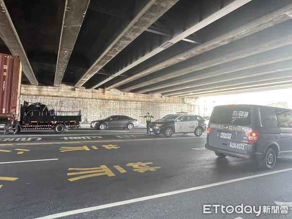 ▲台南市永康區大灣交流道涵洞，20日上午8時52分許，發生1輛貨櫃車卡未注意限高，卡在涵洞下動彈不得，永康分局警方花費約半小時才排除事故狀況。（圖／記者林悅翻攝，下同）