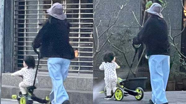 徐佳瑩推著兒子正在騎的三輪車，在台北市松山區附近溜搭。（圖／讀者提供）