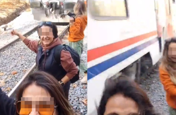 3好友在鐵軌旁自拍　女開心比讚「下秒就被火車撞」驚險畫面曝。（圖／翻攝自推特）