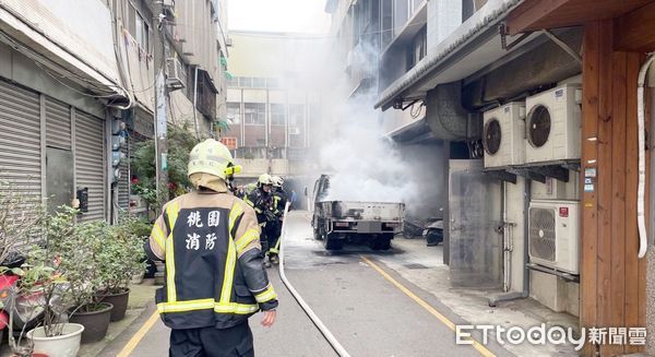 ▲桃園市中壢區中北路上一輛小貨車今天上午在路旁停放時，車斗處突起火燃燒，消防人員據報到場灌救。（圖／記者沈繼昌翻攝）