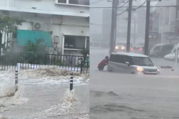 ▲沖繩各地降下破紀錄大雨，民眾整個人泡在水裡推車。（圖／X／@kariyushi19）