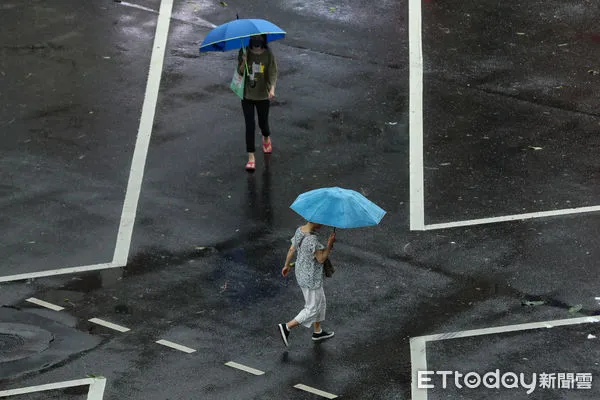 ▲▼凱米颱風逐漸遠離，北市街頭風雨趨緩,天氣,行人路權,路人,雷雨,口罩,斑馬線,過馬路,大雨,大雷雨,下雨,雨天,豪大雨,午後雷陣雨,梅雨,降雨,氣象,豪雨,颱風外圍環流,西南氣流,滯留鋒面,撐傘,雨傘,陰雨綿綿,潮濕,濕度,熱對流,天氣配圖。（圖／記者李毓康攝）