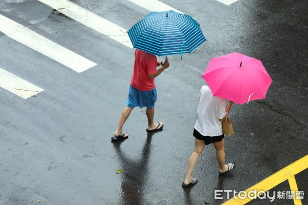 ▲▼凱米颱風逐漸遠離，北市街頭風雨趨緩,天氣,行人路權,路人,雷雨,口罩,斑馬線,過馬路,大雨,大雷雨,下雨,雨天,豪大雨,午後雷陣雨,梅雨,降雨,氣象,豪雨,颱風外圍環流,西南氣流,滯留鋒面,撐傘,雨傘,陰雨綿綿,潮濕,濕度,熱對流,天氣配圖。（圖／記者李毓康攝）