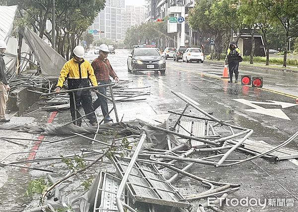 ▲桃園市龜山區文化一路、樂善二路一處工地鷹架，下午遭強風襲擊倒塌，龜山警方封鎖道路，工人忙著清理鷹架。（圖／記者沈繼昌翻攝）