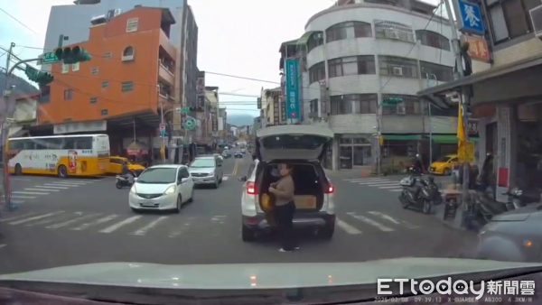 ▲自小客車大剌剌違停在馬路中央，讓一名女性乘客下車當街穿衣取物。（圖／翻攝「爆料公社二社」臉書社團，下同）