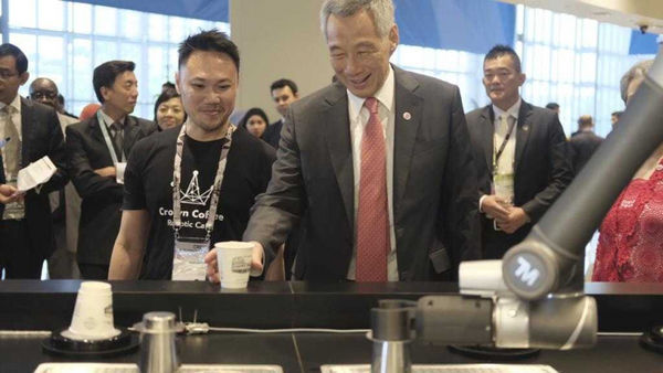 達明的機械手臂化身為全自動機器人咖啡師 「Ella」，在新加坡連鎖咖啡廳Crown Coffee裡泡咖啡，時任新加坡總理李顯龍也喝了一杯。（圖／翻攝自ella咖啡館臉書）