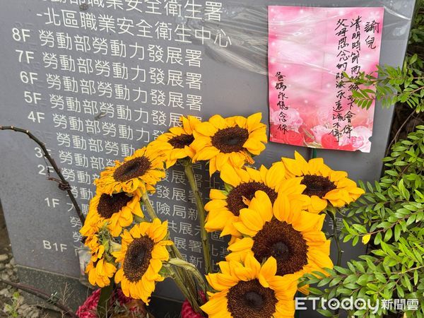 ▲北分署霸凌案中輕生的吳姓公務員，父母在北分署大門前張貼弔唁標語與向日葵，表達對孩子的思念（圖／記者唐鎮宇攝）