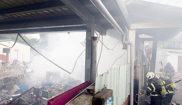 ▲桃園市平鎮區延平路上一家戶外回收場下午傳出大火，消防人員架設水線搶救中。（圖／桃園市消防局提供）