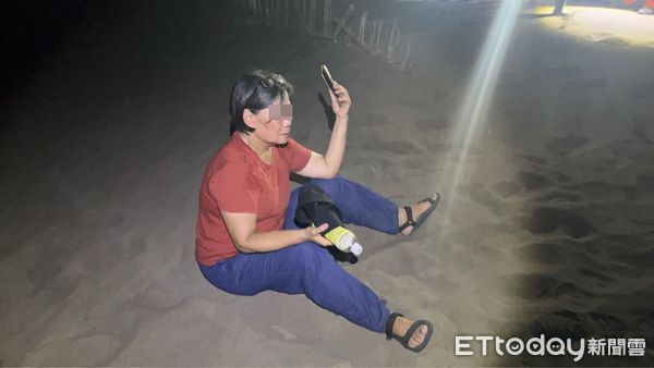 ▲苗栗林姓婦人誤闖海邊沙丘，體力耗盡受困才報案，救災人員花費約1小時才尋獲，攙扶她平安脫困            。（圖／記者楊永盛翻攝）