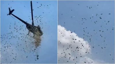 天空下起「鈔票雨」!他搭直升機撒錢 感人原因曝光