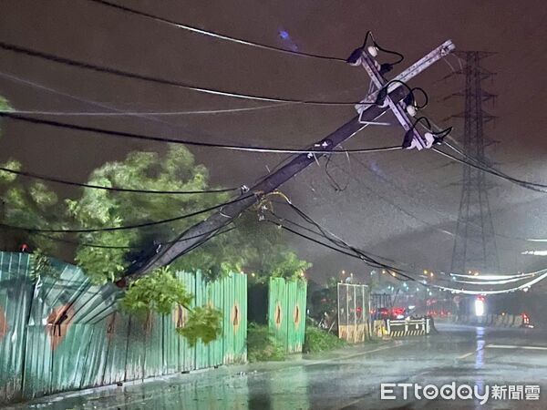 ▲台南市多處因丹娜絲颱風導致電線桿倒塌，工程人員正冒雨搶修中。（記者林東良翻攝，下同）