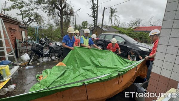 ▲台南市做工行善團志工冒雨搶修七股區災損住家屋頂，協助加蓋帆佈防止漏水惡化。（記者林東良翻攝，下同）