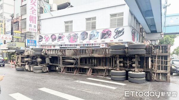 ▲一輛貨櫃車行經八德區中華路左轉龍壽街時，疑因速度過快失控翻覆，差點撞進路旁安全帽店內。（圖／記者沈繼昌翻攝）